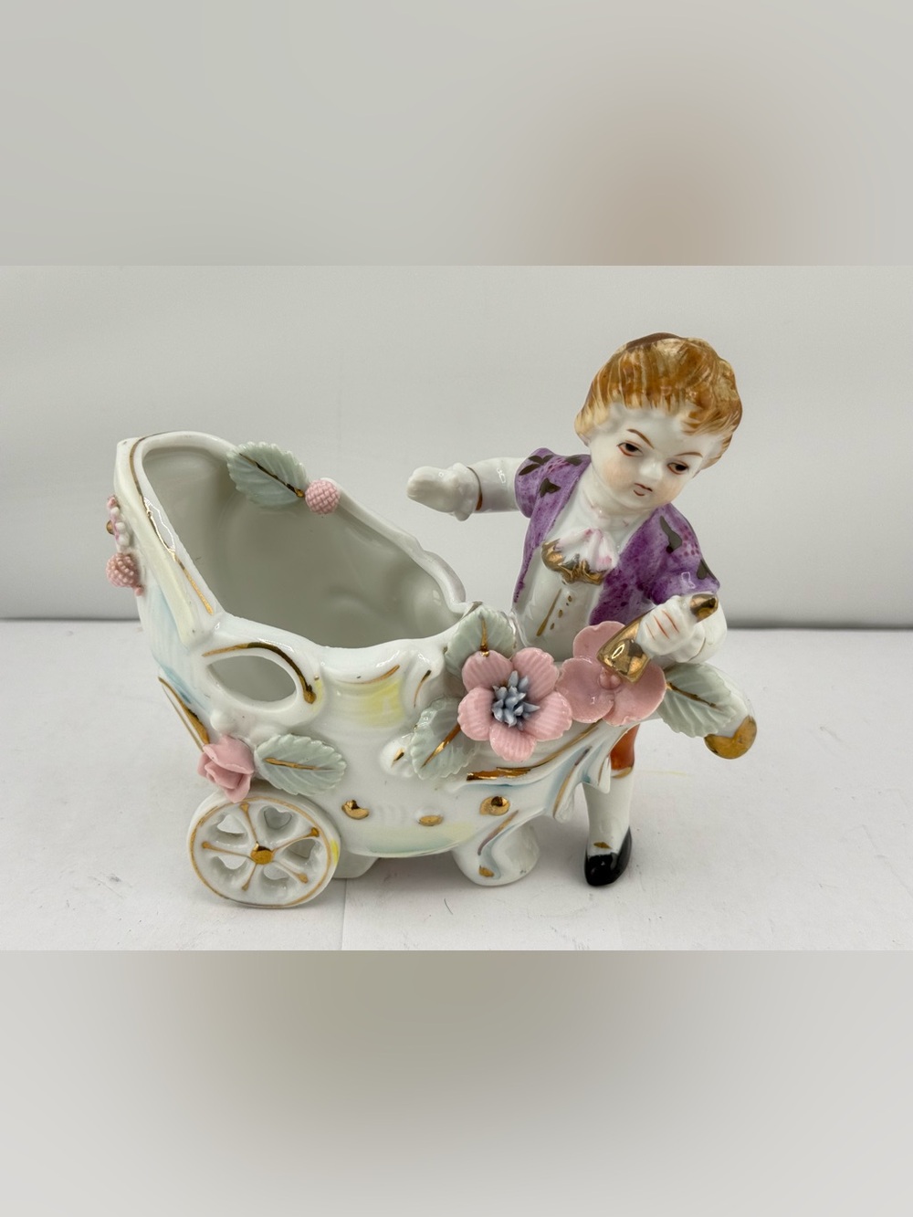 Vintage porcelain boy with a flower cart planter